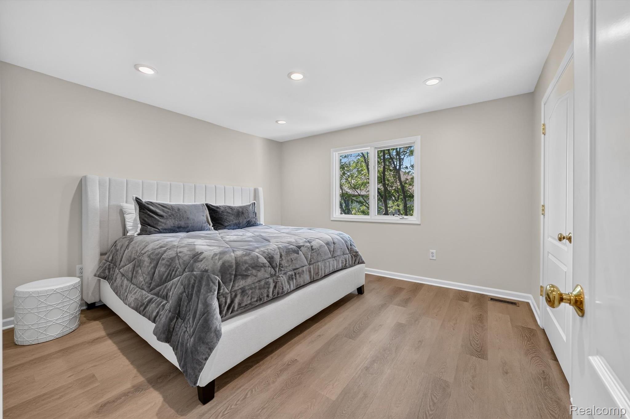 3804 Elk Drive Rochester, MI 48306 - Photo 35 of 75 Spacious bedroom featuring light luxury vinyl flooring, recessed lighting, neutral wall paint, white trim, and a window offering natural light