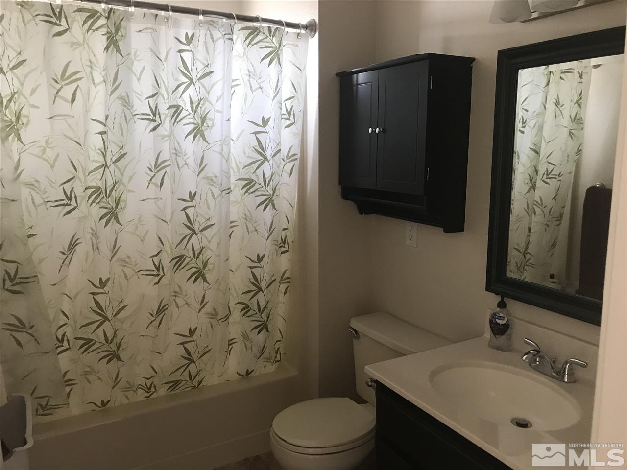 1820 Rice Road Fallon, NV 89406 - Photo 12 of 17 a bathroom with a shower curtain sink and a toilet