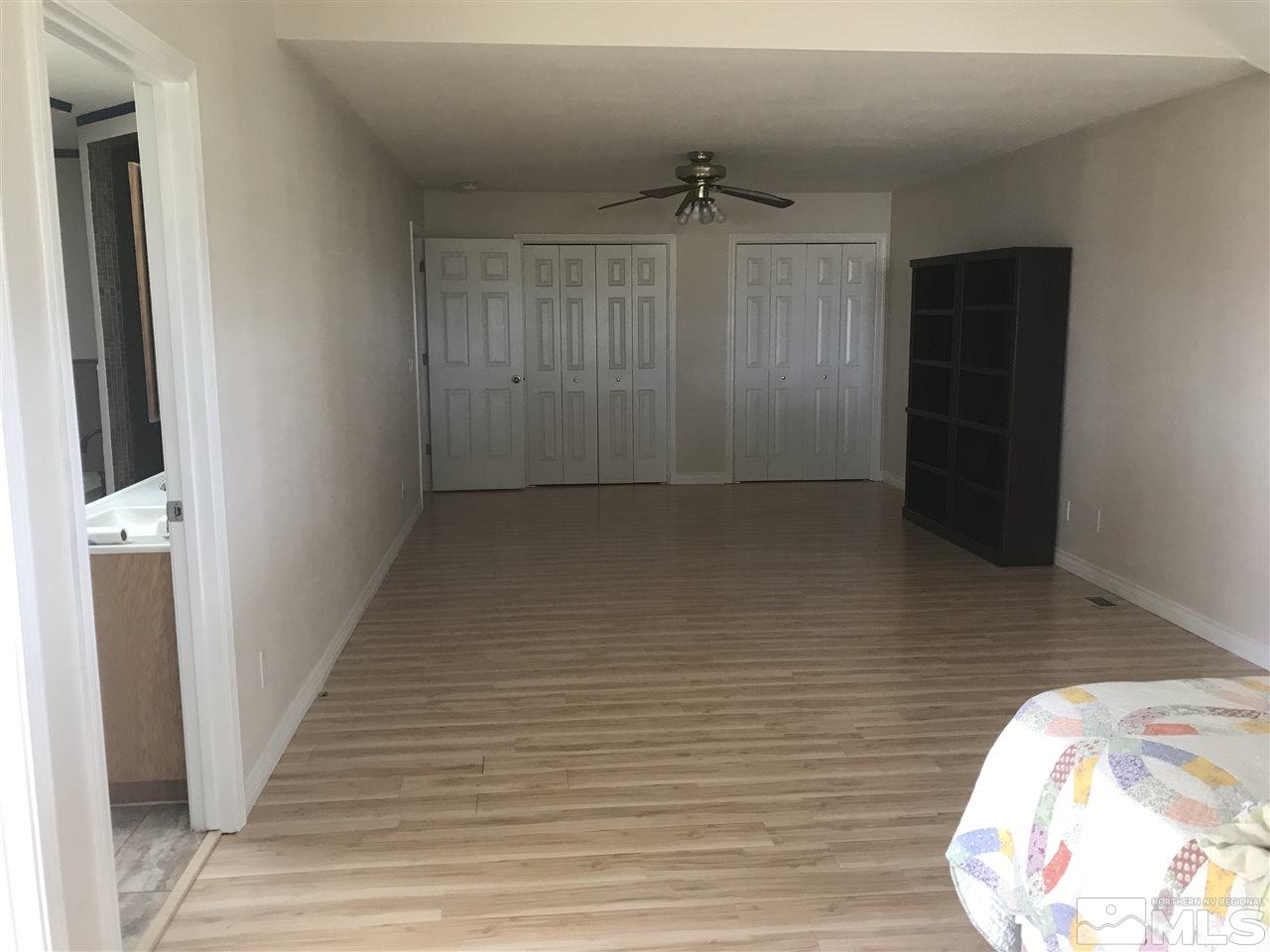 1820 Rice Road Fallon, NV 89406 - Photo 17 of 17 a view of a hallway with wooden floor
