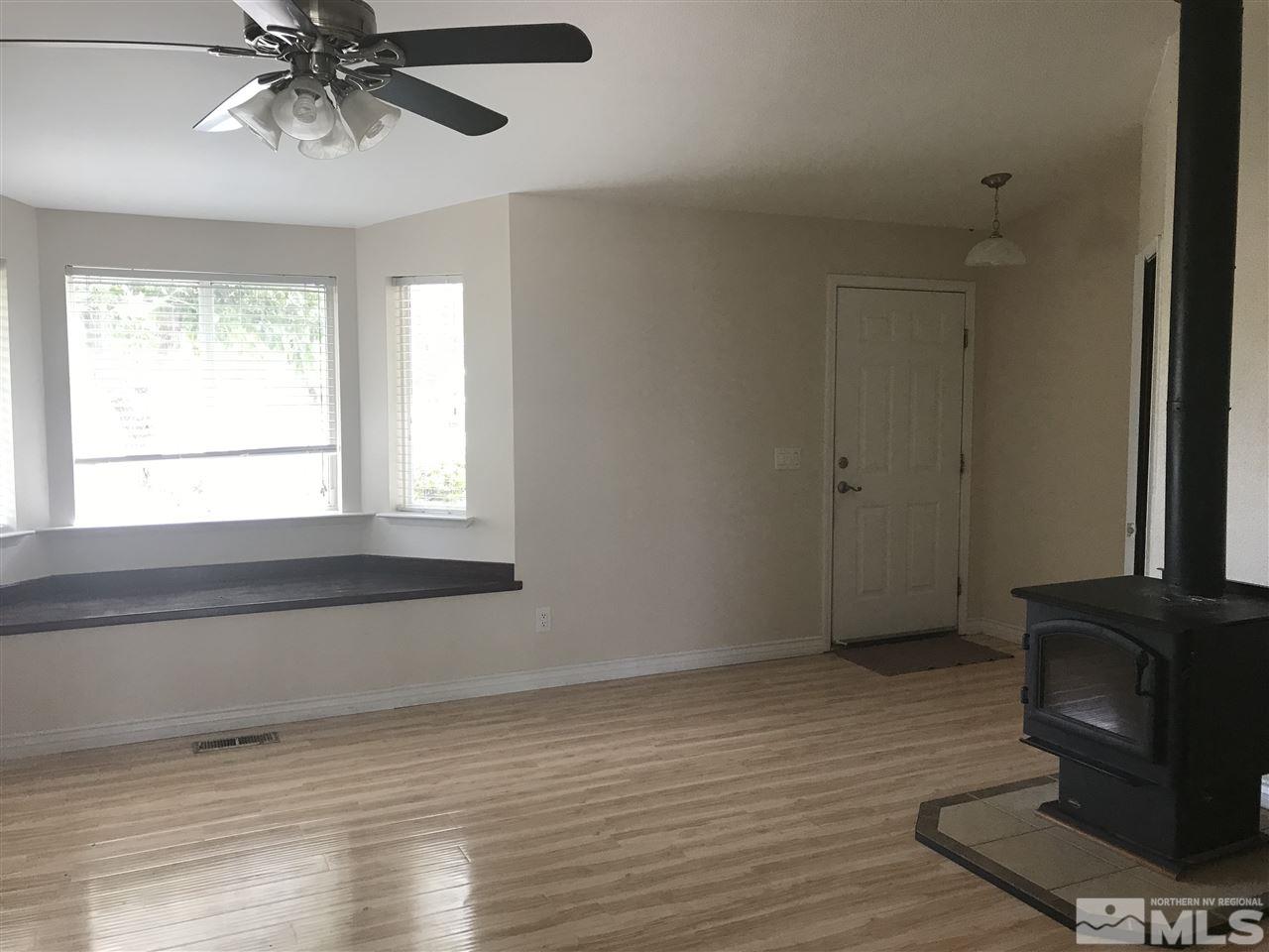 1820 Rice Road Fallon, NV 89406 - Photo 7 of 17 a view of an empty room with wooden floor and a window