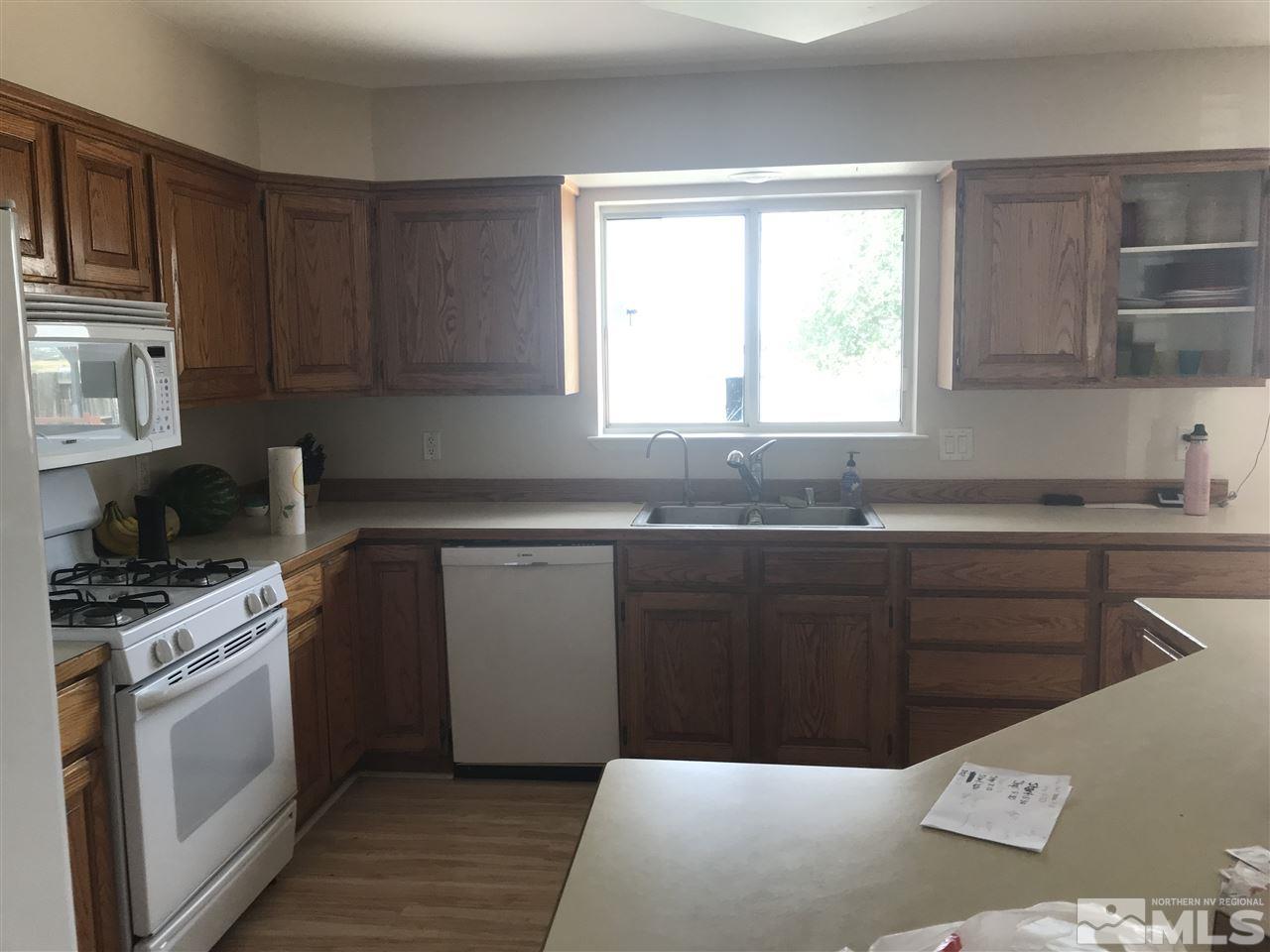 1820 Rice Road Fallon, NV 89406 - Photo 9 of 17 a kitchen with granite countertop a sink cabinets stainless steel appliances and a window