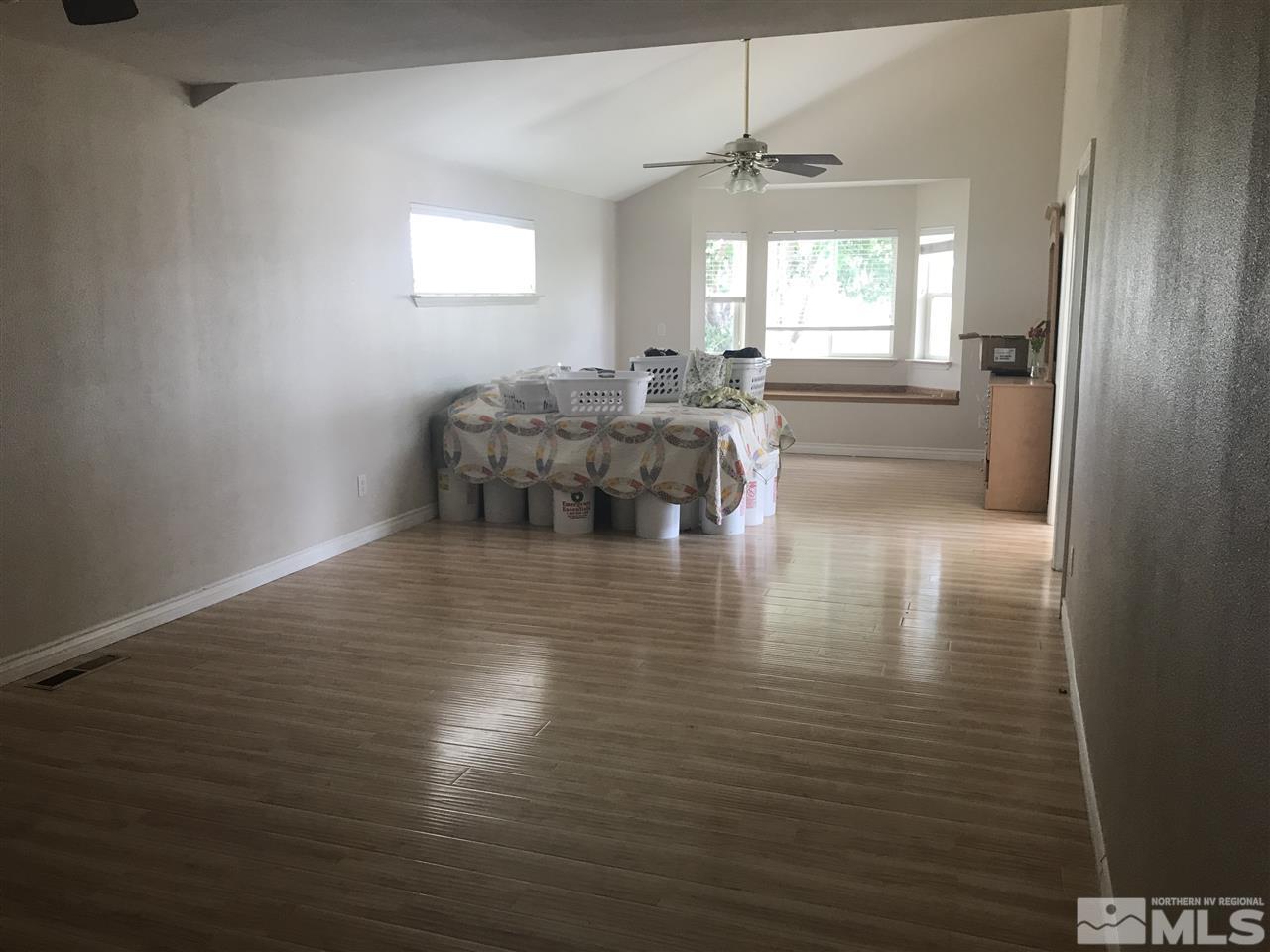 1820 Rice Road Fallon, NV 89406 - Photo 10 of 17 an empty room with wooden floor and windows