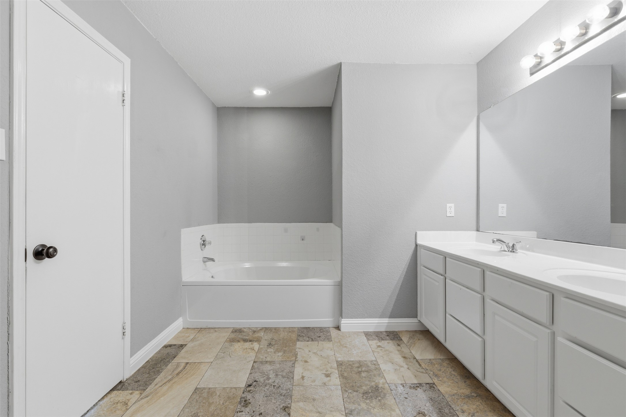 1715 Ruthie Run Cedar Park, TX 78613 - Photo 17 of 25 Bathroom with double vanity, a soaking tub, and recessed lighting