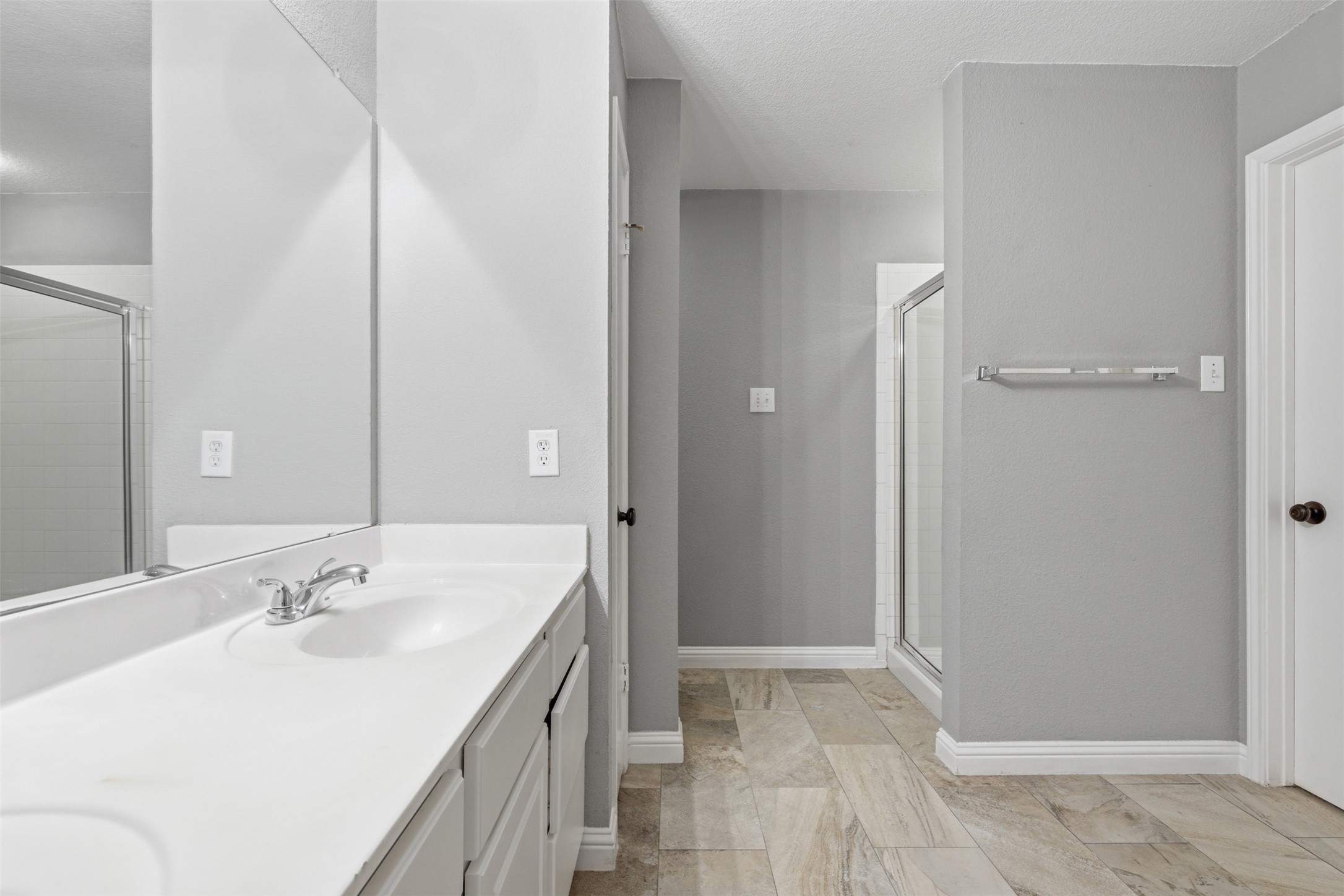 1715 Ruthie Run Cedar Park, TX 78613 - Photo 18 of 25 Bathroom featuring double vanity, a stall shower, and a walk-in closet
