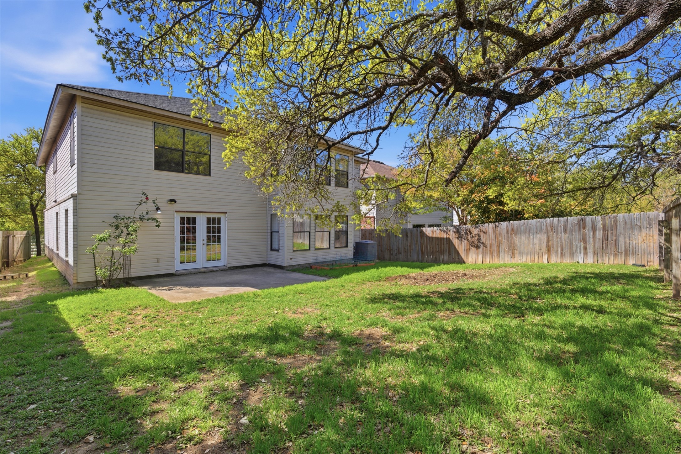1715 Ruthie Run Cedar Park, TX 78613 - Photo 24 of 25 Rear view of property with a fenced backyard, a patio, and french doors
