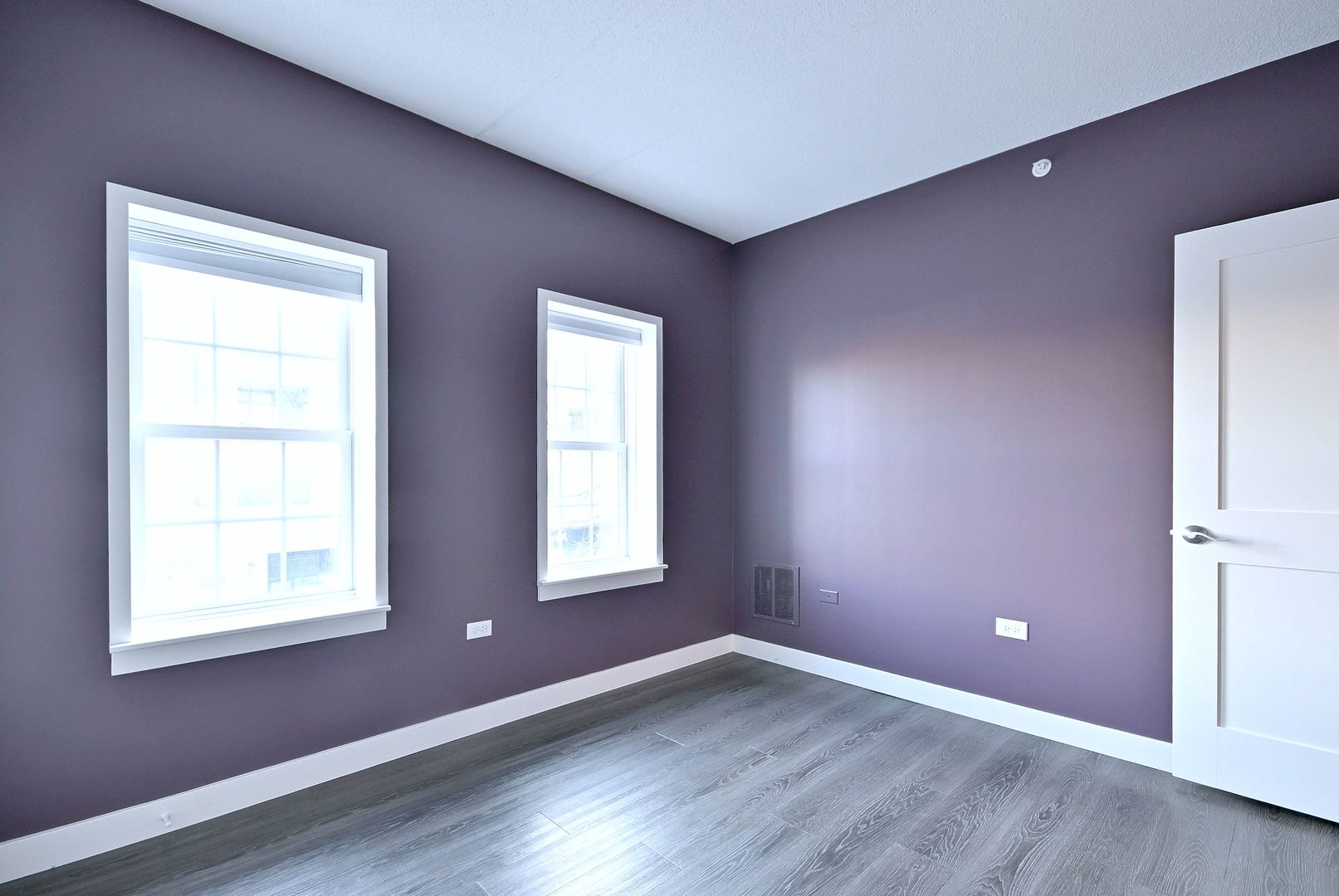 210 North Addison Avenue, Unit 303 Elmhurst, IL 60126 - Photo 13 of 20 an empty room with wooden floor and windows