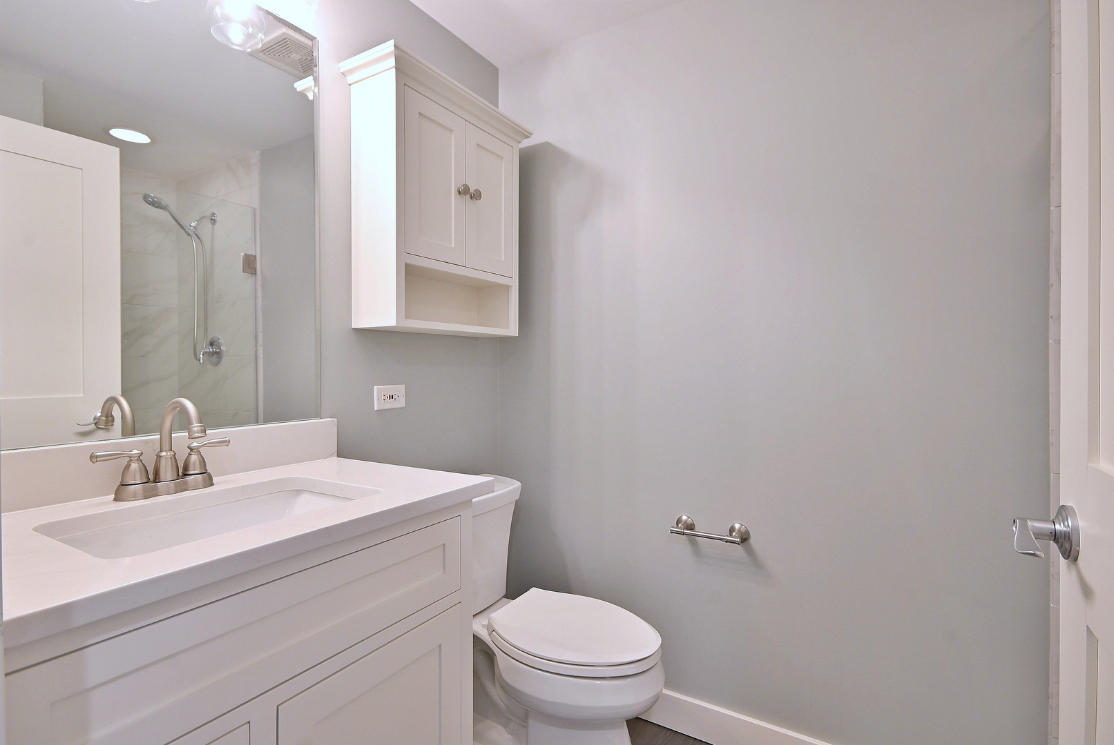 210 North Addison Avenue, Unit 303 Elmhurst, IL 60126 - Photo 14 of 20 a bathroom with a sink a toilet and a mirror