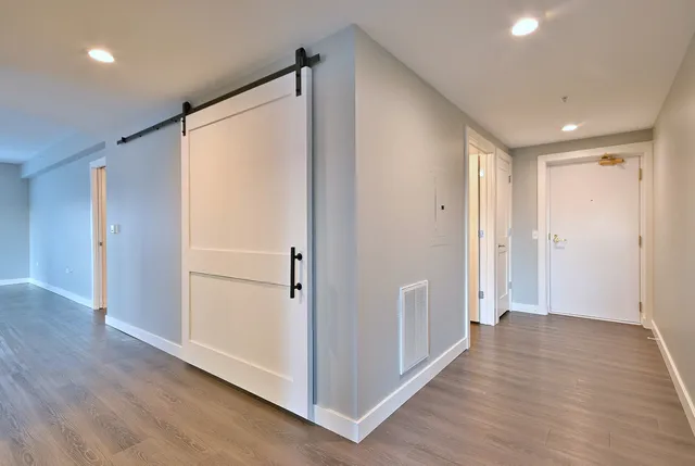 a view of a hallway with wooden floor