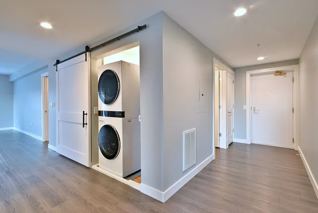 a view of a hallway with washer and dryer