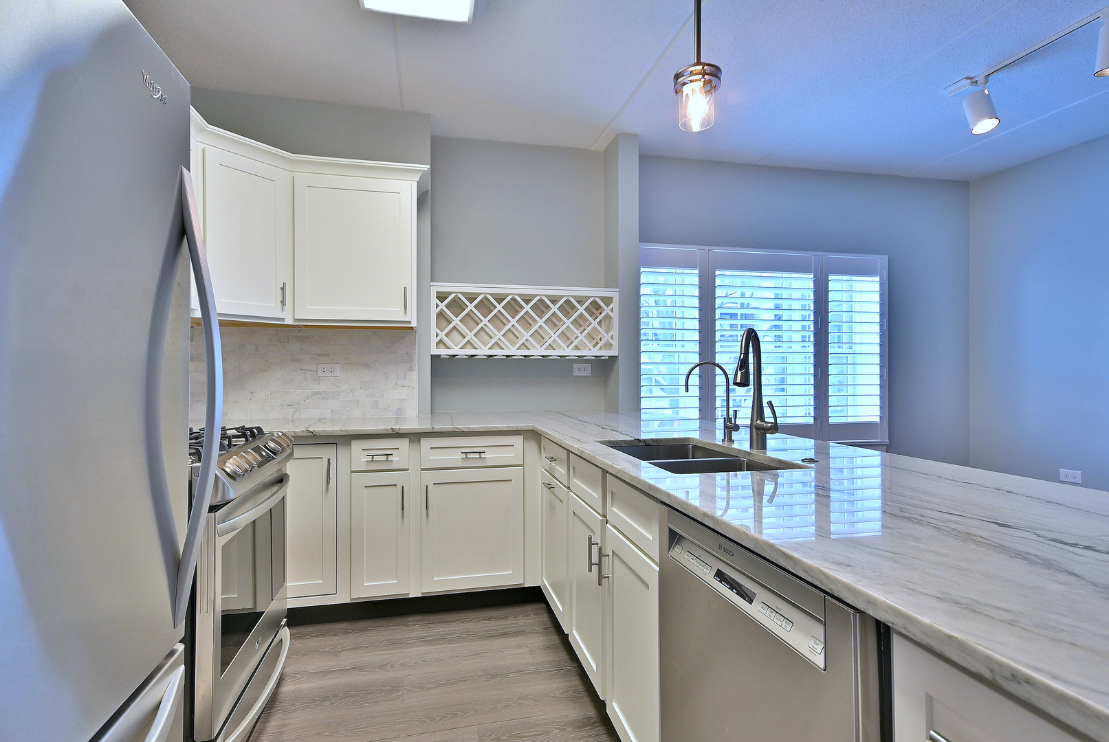 210 North Addison Avenue, Unit 303 Elmhurst, IL 60126 - Photo 4 of 20 a kitchen that has a sink and a stove