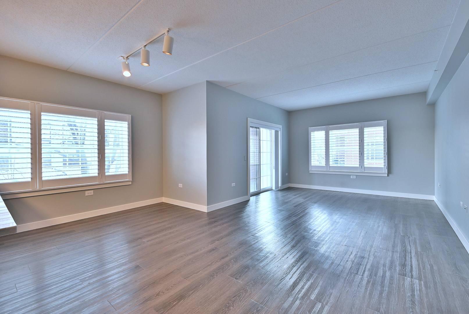210 North Addison Avenue, Unit 303 Elmhurst, IL 60126 - Photo 6 of 20 a view of an empty room with wooden floor and a window