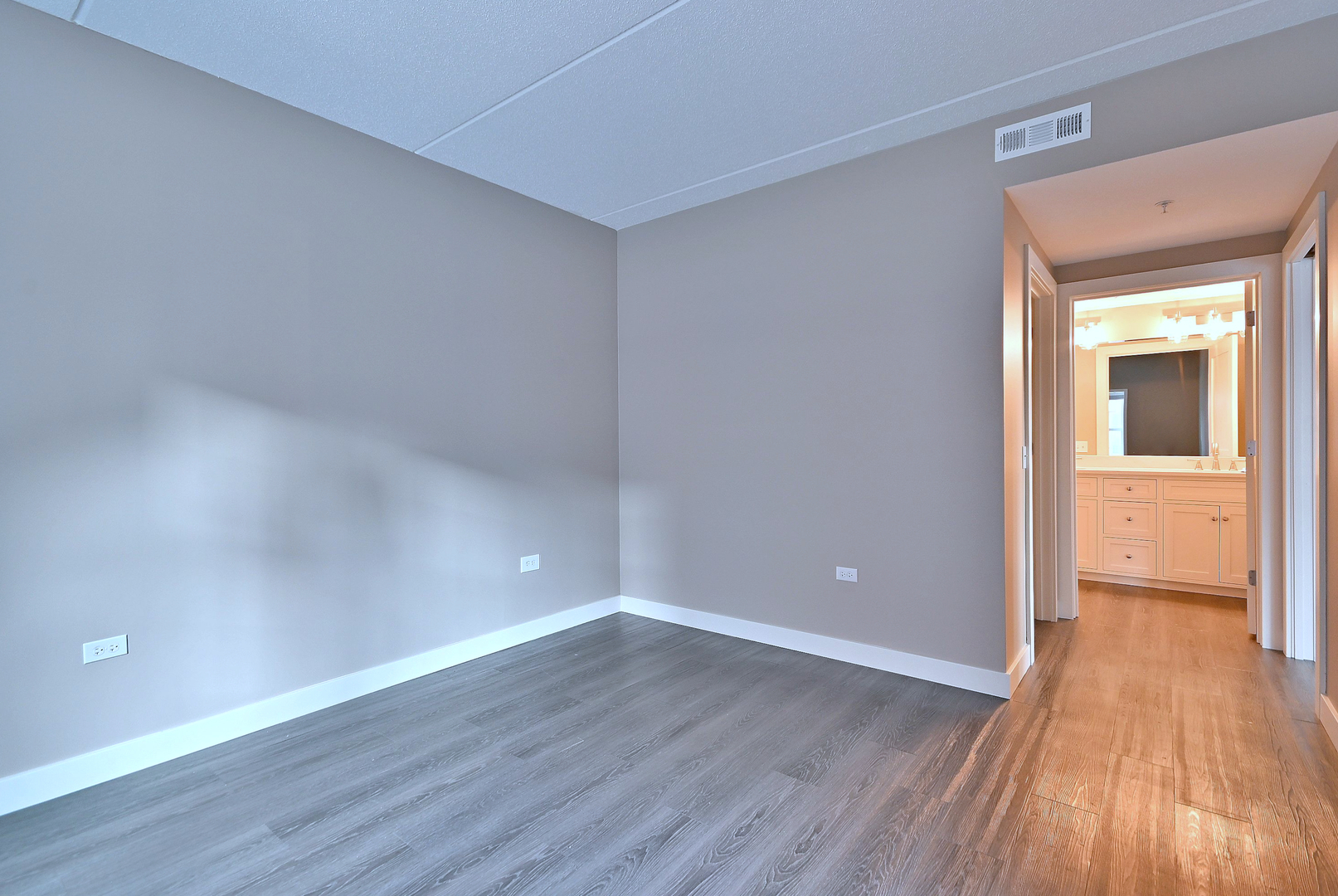 210 North Addison Avenue, Unit 303 Elmhurst, IL 60126 - Photo 9 of 20 an empty room with wooden floor and windows