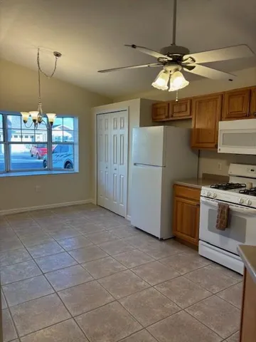 a kitchen with stainless steel appliances granite countertop a stove a refrigerator and a sink