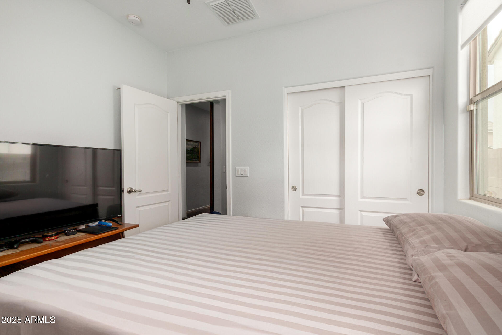 3440 North Mayfair Mesa, AZ 85213 - Photo 22 of 31 a bedroom with a bed and a flat screen tv