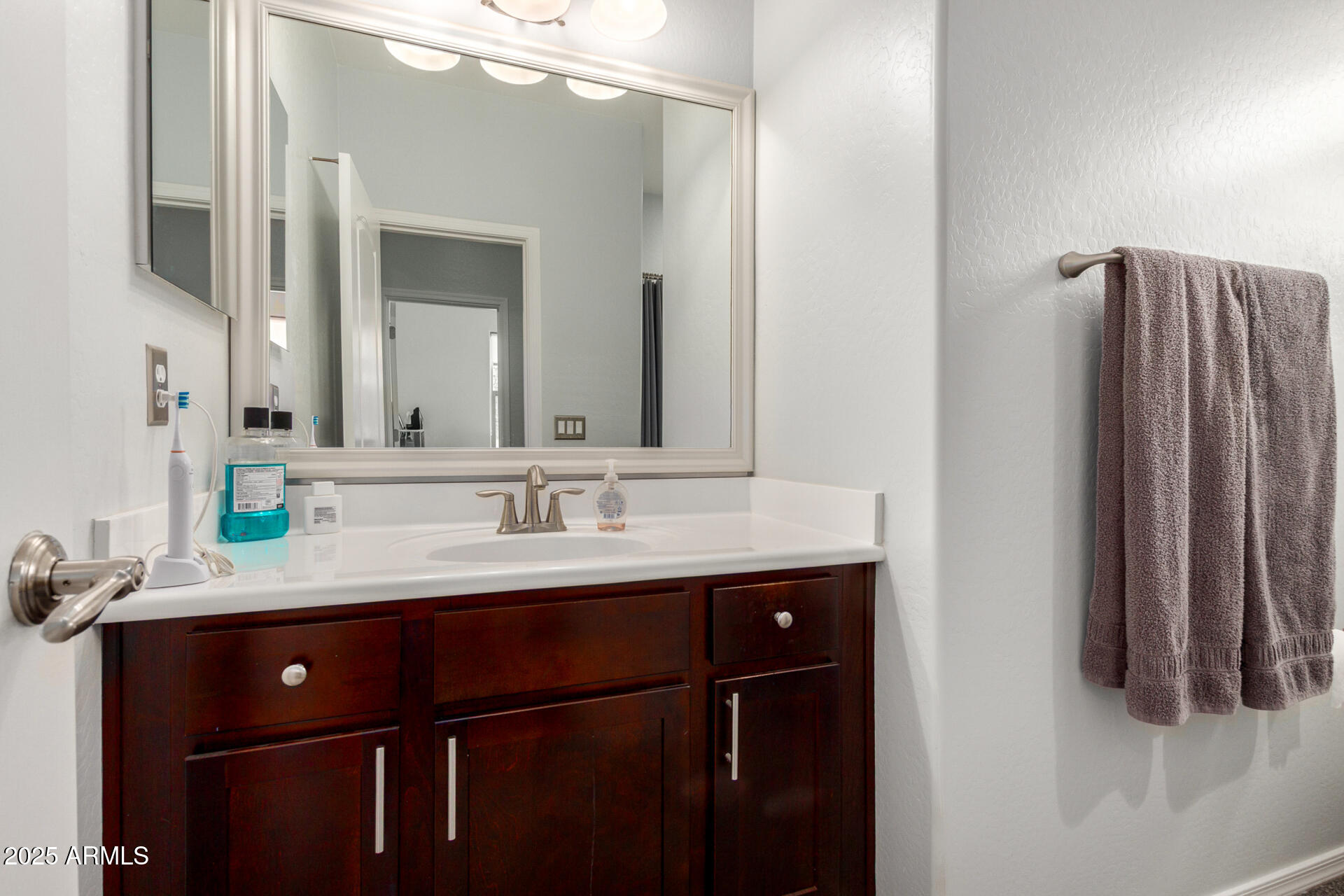 3440 North Mayfair Mesa, AZ 85213 - Photo 23 of 31 a bathroom with a sink a mirror and a shower