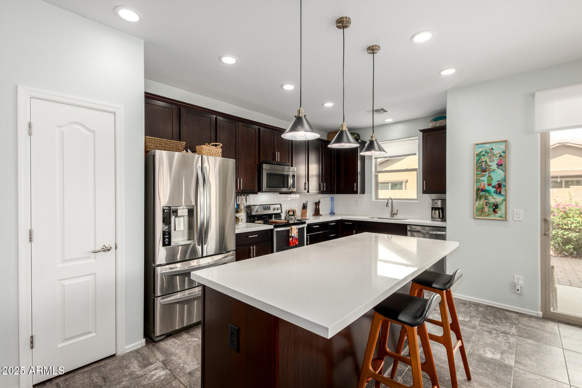 3440 North Mayfair Mesa, AZ 85213 - Photo 10 of 31 a kitchen with stainless steel appliances a kitchen island a refrigerator a stove and a sink