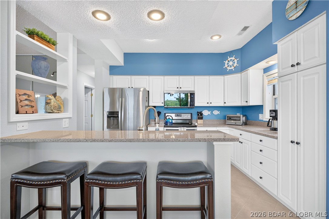 73 Evergreen Road, Unit 3A Sunrise Beach, MO 65079 - Photo 19 of 89 Bright, and beautifully updated white kitchen that