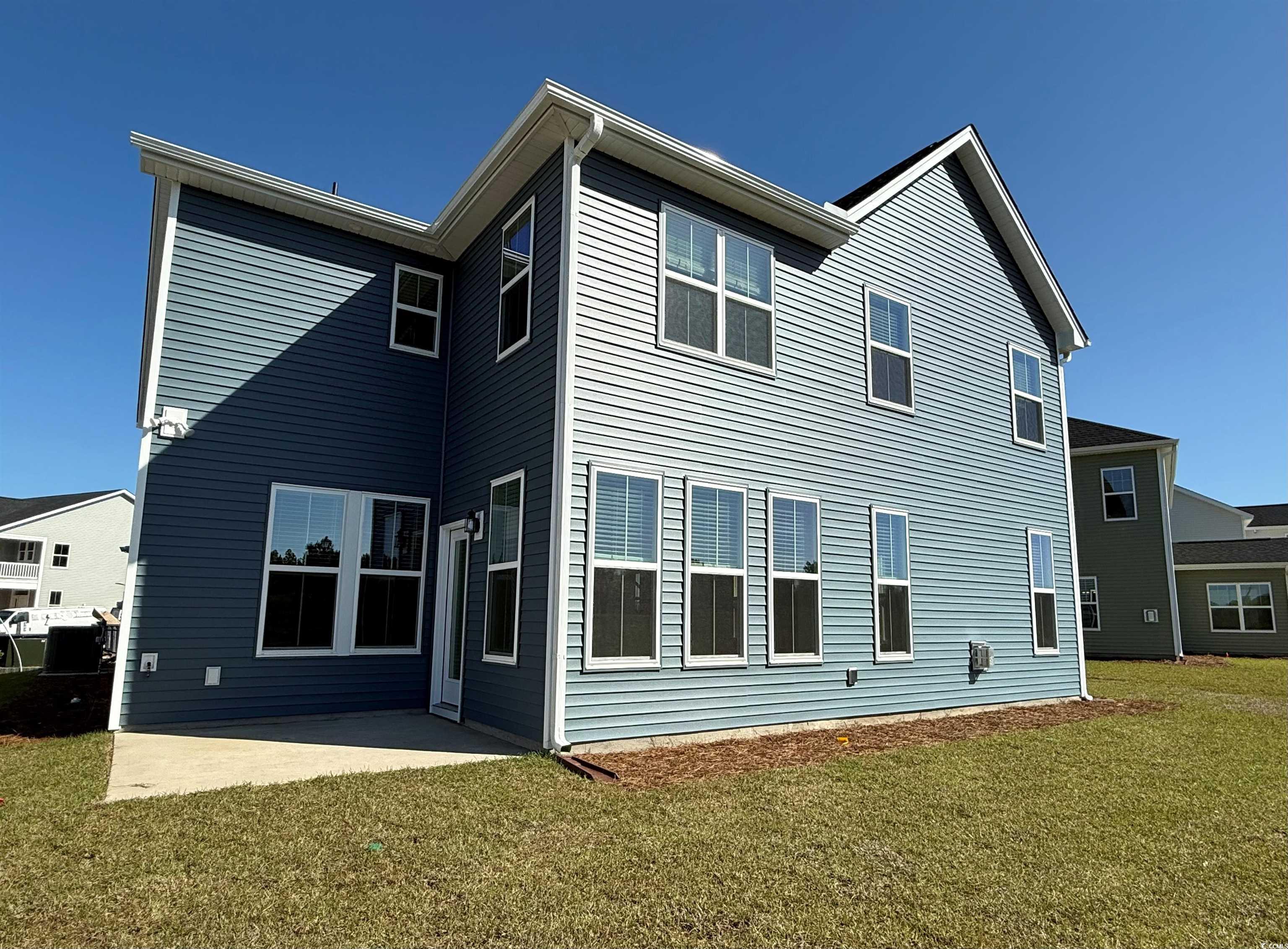 4052 Bucolic Loop Myrtle Beach, SC 29588 - Photo 2 of 31 Back of property featuring a lawn and a patio
