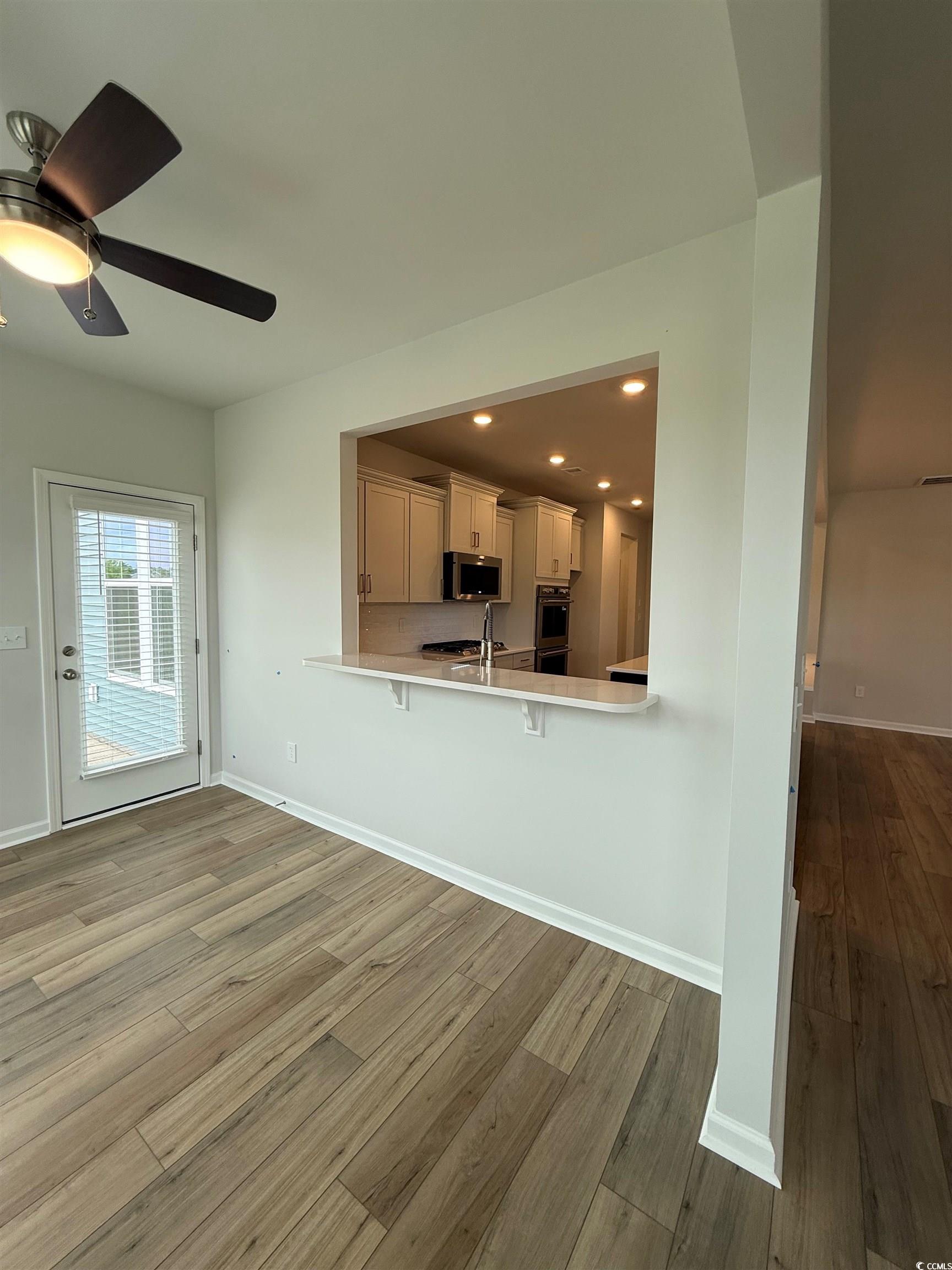 4052 Bucolic Loop Myrtle Beach, SC 29588 - Photo 3 of 31 Kitchen with a breakfast bar, light countertops, a