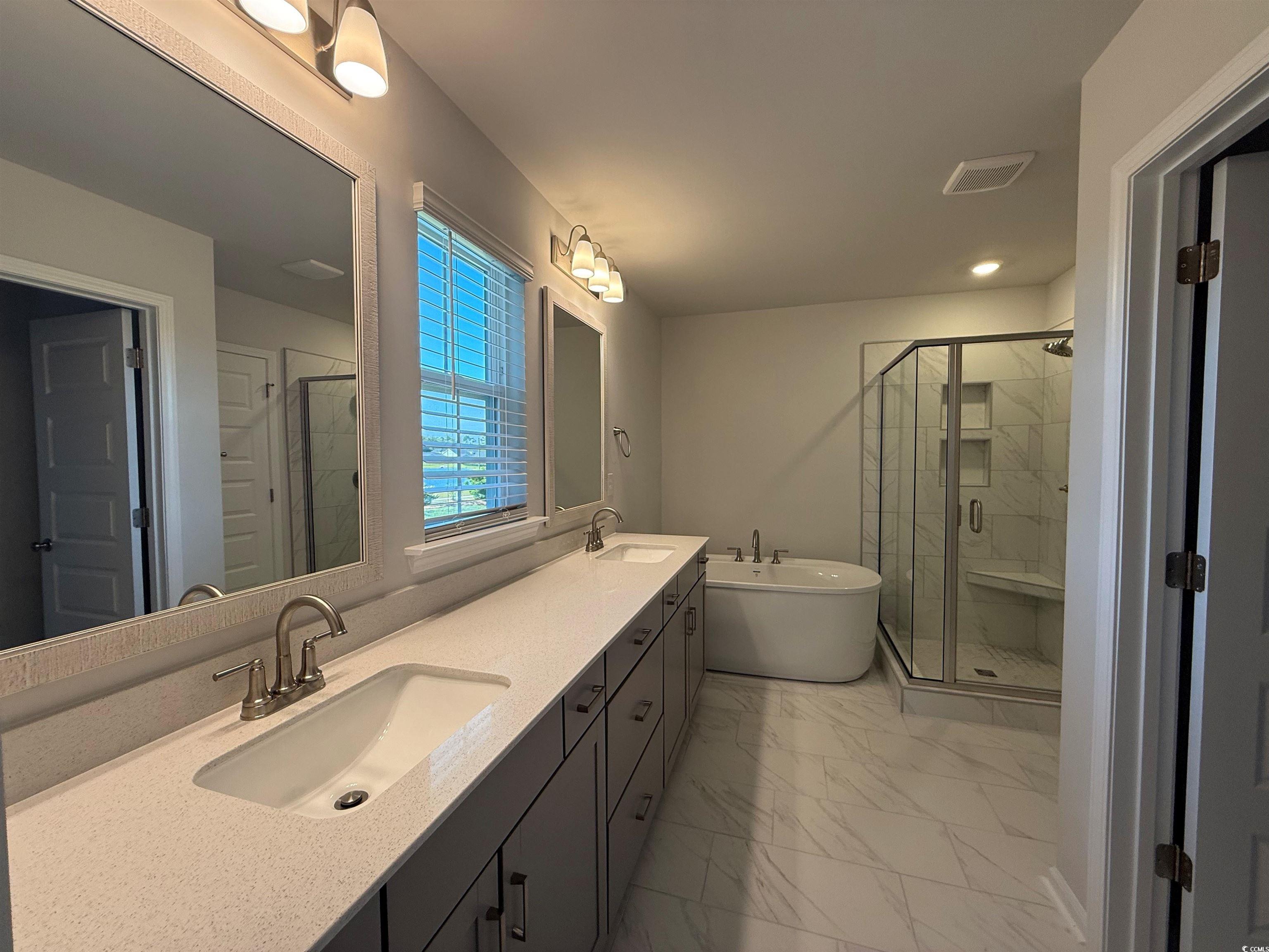 4052 Bucolic Loop Myrtle Beach, SC 29588 - Photo 8 of 31 Full bath with a freestanding bath, a sink, marble