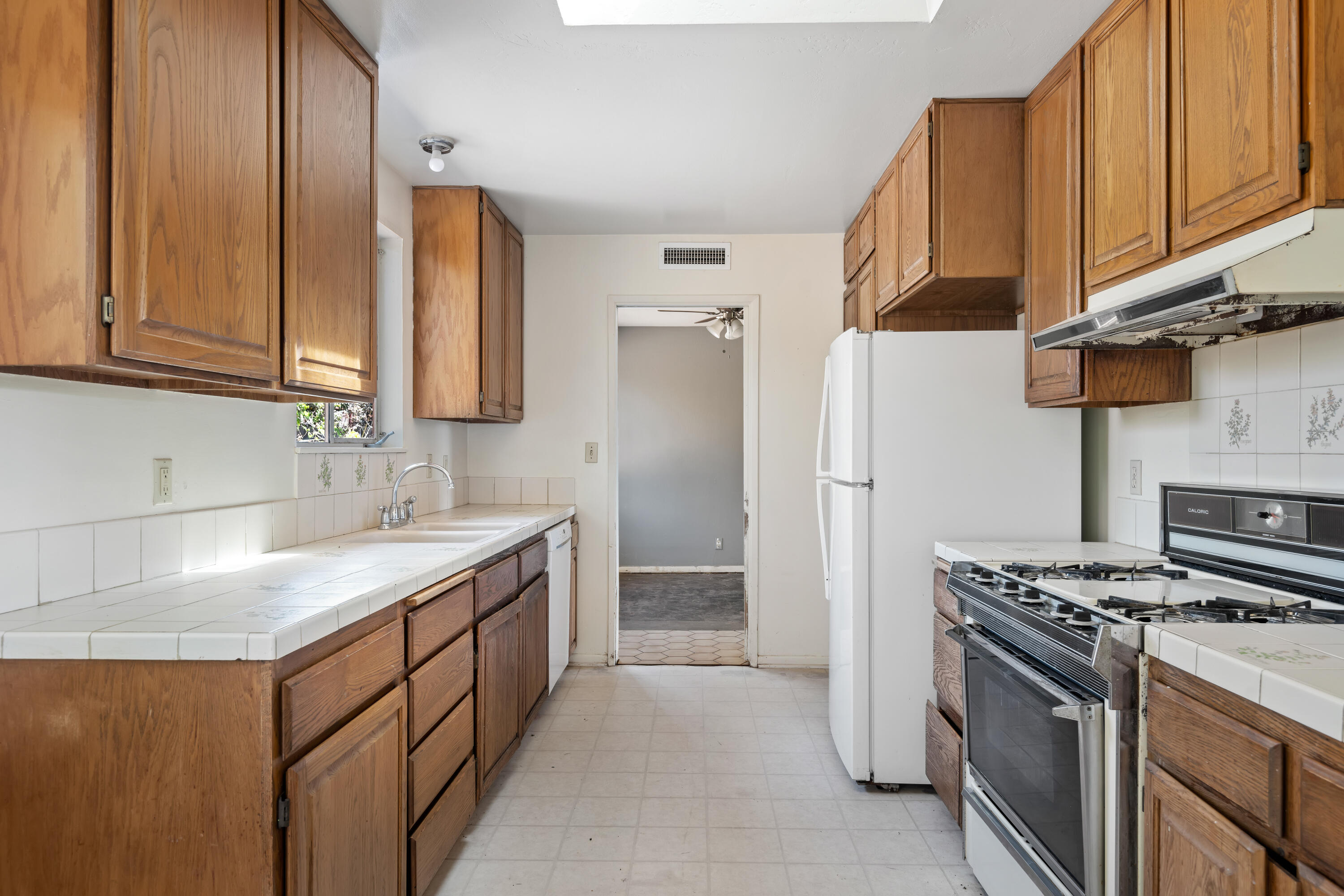 6242 Guava Avenue Goleta, CA 93117 - Photo 8 of 19 a kitchen with stainless steel appliances granite countertop a sink stove and refrigerator