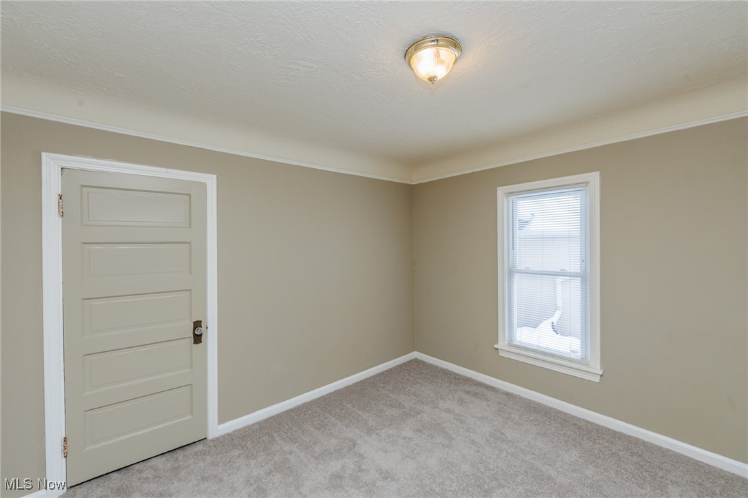 5062 Lee Road Maple Heights, OH 44137 - Photo 18 of 50 Spare room with light carpet and a textured ceiling