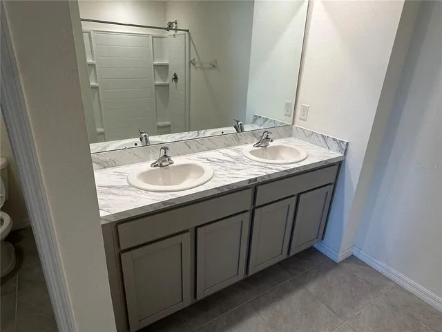 a bathroom with a glass shower door