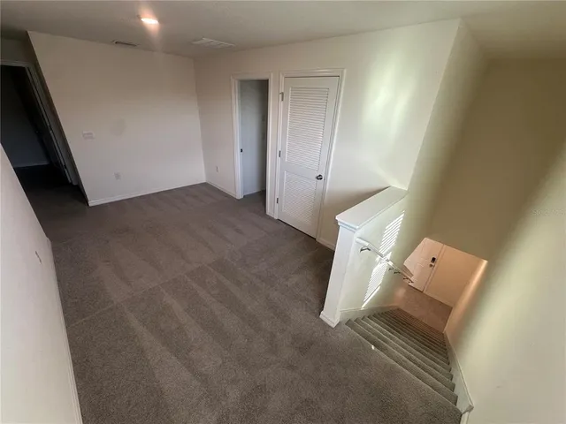 a view of a hallway to rooms