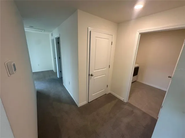 a bathroom with a granite countertop sink a toilet a mirror and shower