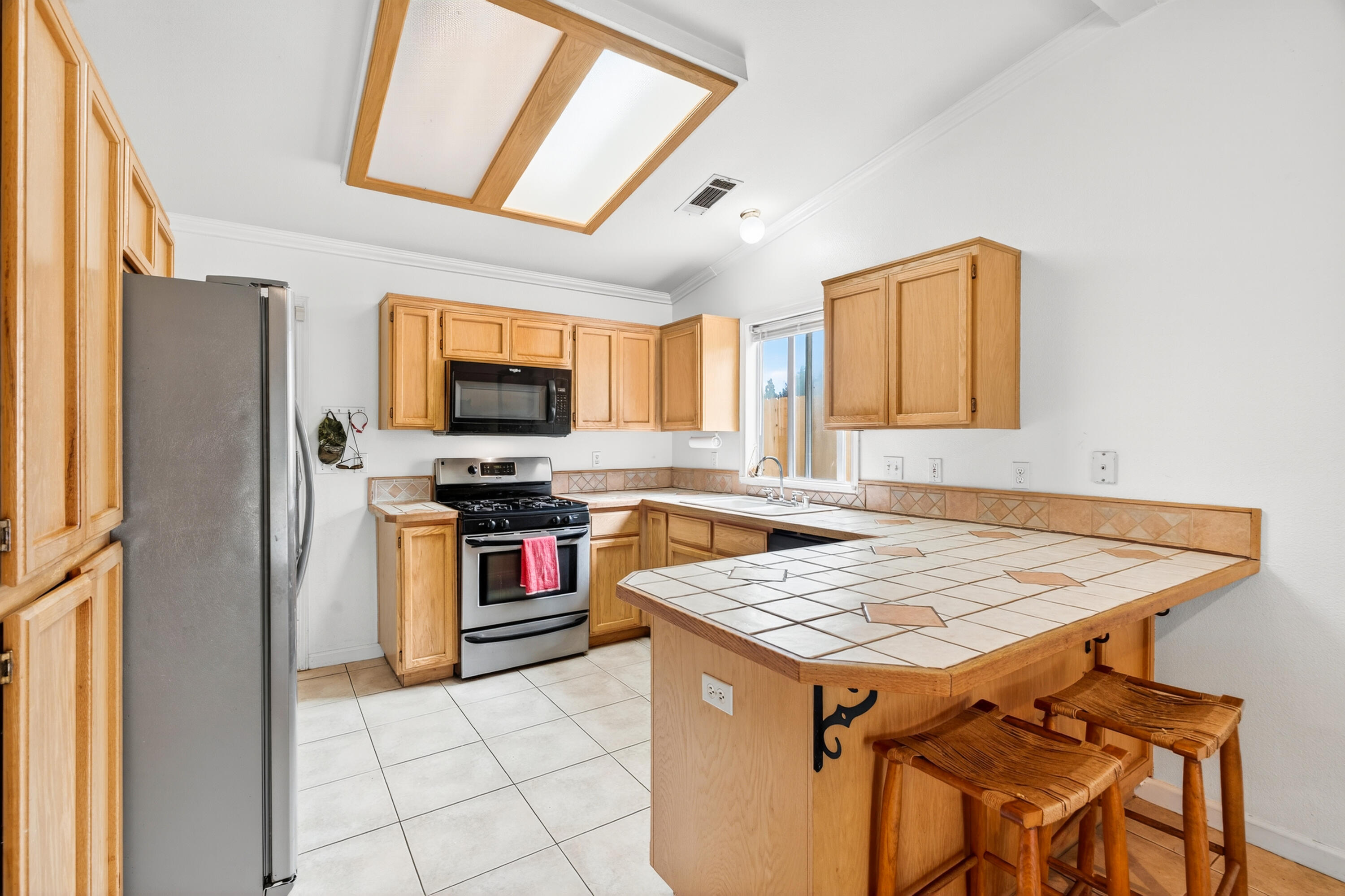 40 Ortega Court Redding, CA 96003 - Photo 12 of 29 a kitchen with a stove a sink and a refrigerator