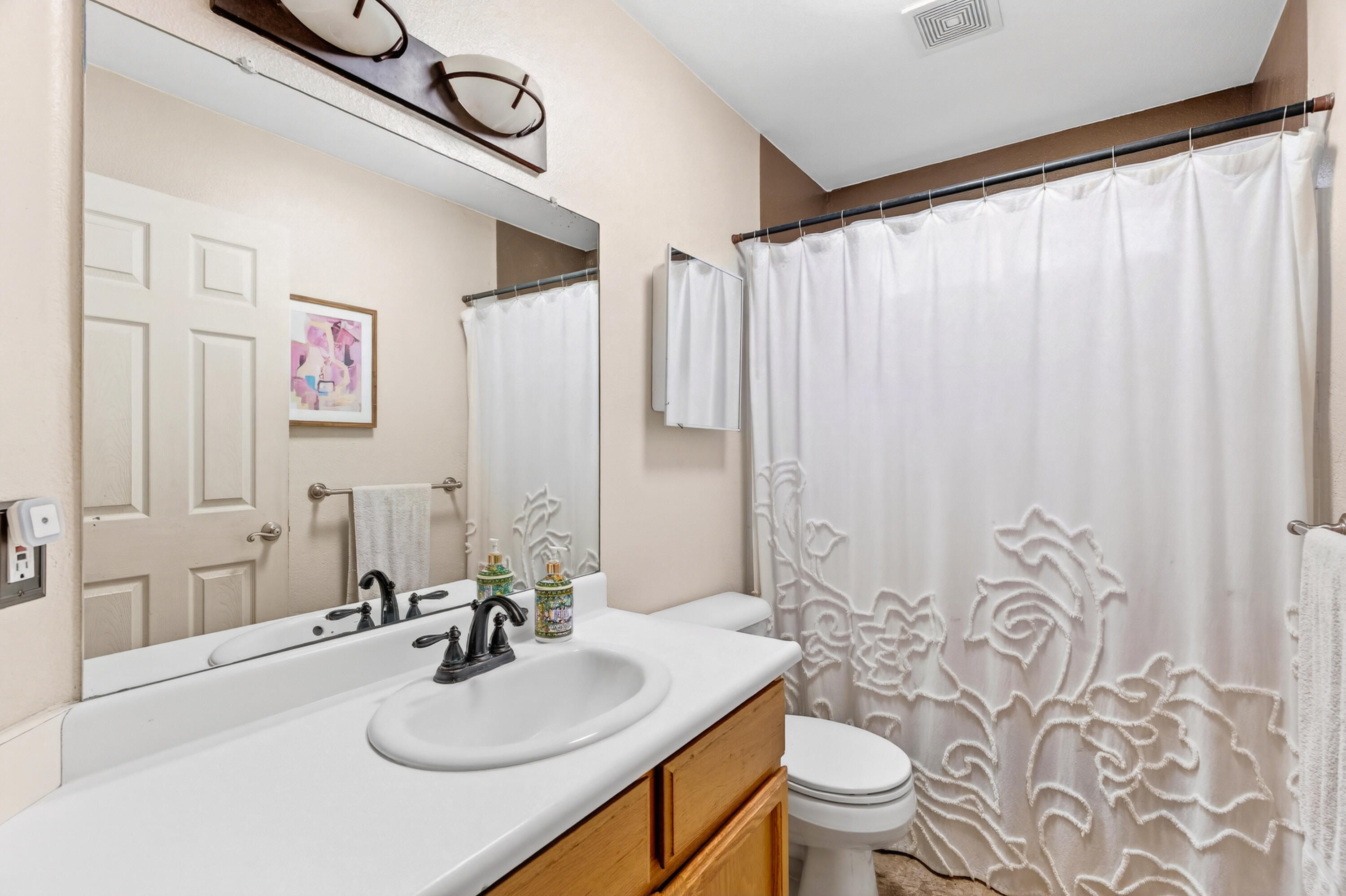 40 Ortega Court Redding, CA 96003 - Photo 16 of 29 a bathroom with a sink a toilet and shower curtain