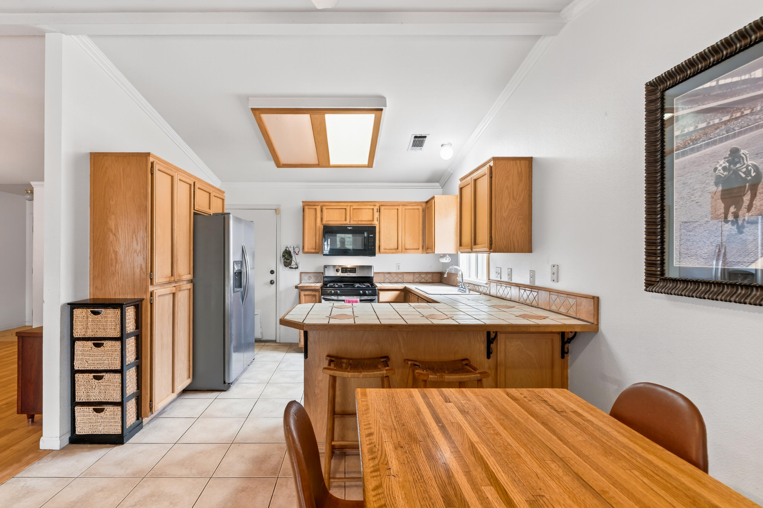 40 Ortega Court Redding, CA 96003 - Photo 7 of 29 a view of a kitchen with kitchen island a stove a refrigerator and a sink