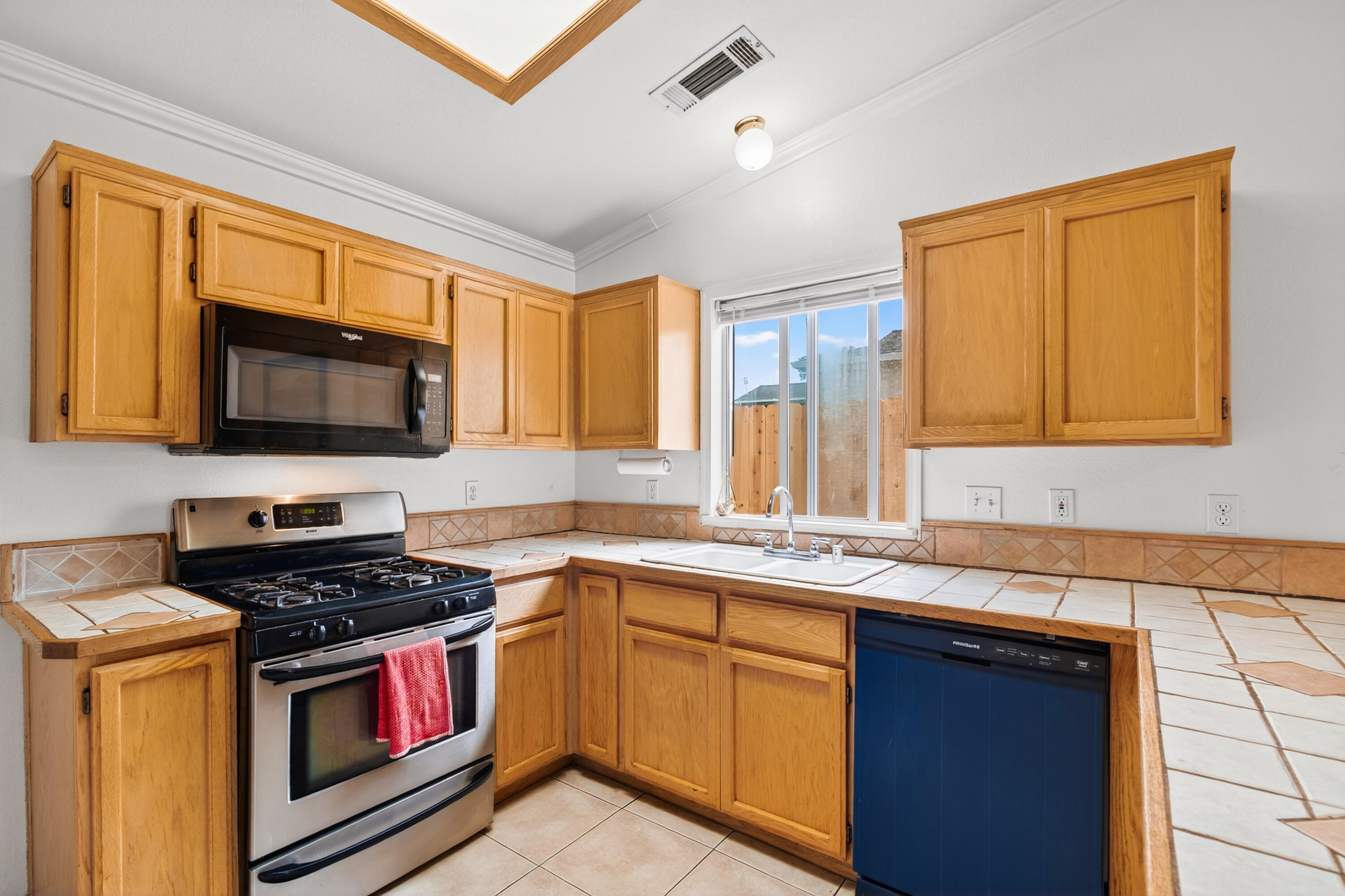 40 Ortega Court Redding, CA 96003 - Photo 8 of 29 a kitchen with stainless steel appliances a stove sink and microwave