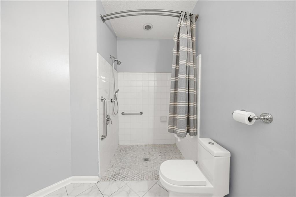 10 Perimeter Summit Boulevard, Unit 3107 Atlanta, GA 30319 - Photo 13 of 44 a bathroom with a toilet and a shower
