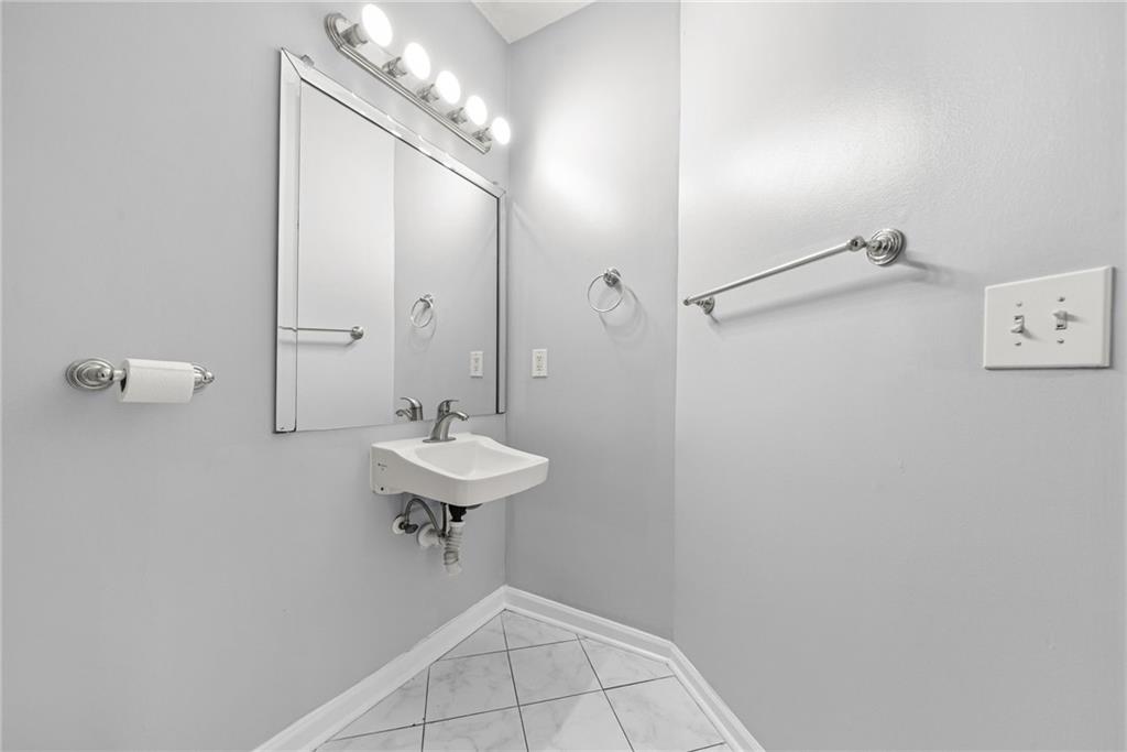 10 Perimeter Summit Boulevard, Unit 3107 Atlanta, GA 30319 - Photo 14 of 44 a bathroom with a sink a mirror and a shower