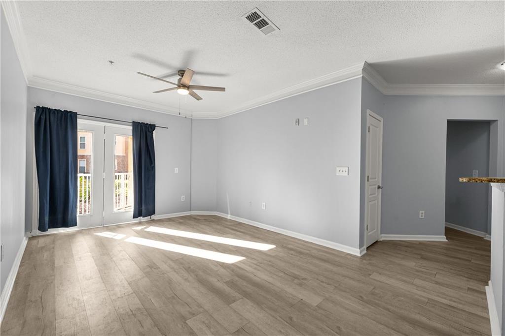 10 Perimeter Summit Boulevard, Unit 3107 Atlanta, GA 30319 - Photo 8 of 44 a view of an empty room with window and wooden floor