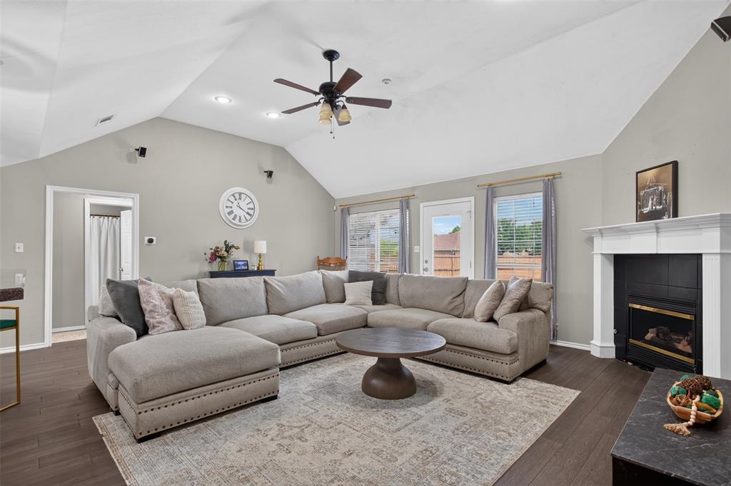 100 Radecke Road Krum, TX 76249 - Photo 11 of 29 Spacious living area featuring vaulted ceilings, dark wood-finish flooring, and recessed lighting