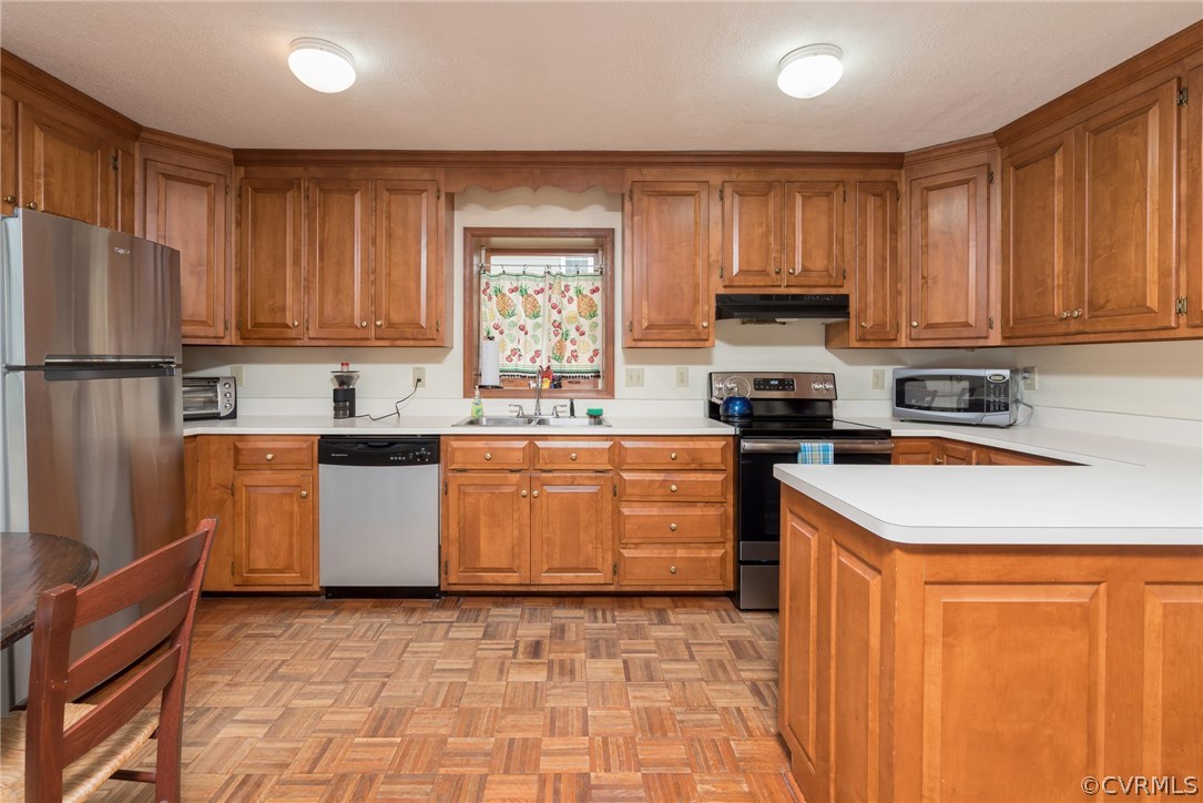 7618 Hollins Road Henrico, VA 23229 - Photo 15 of 15 a kitchen with stainless steel appliances granite countertop a stove a sink dishwasher and a refrigerator