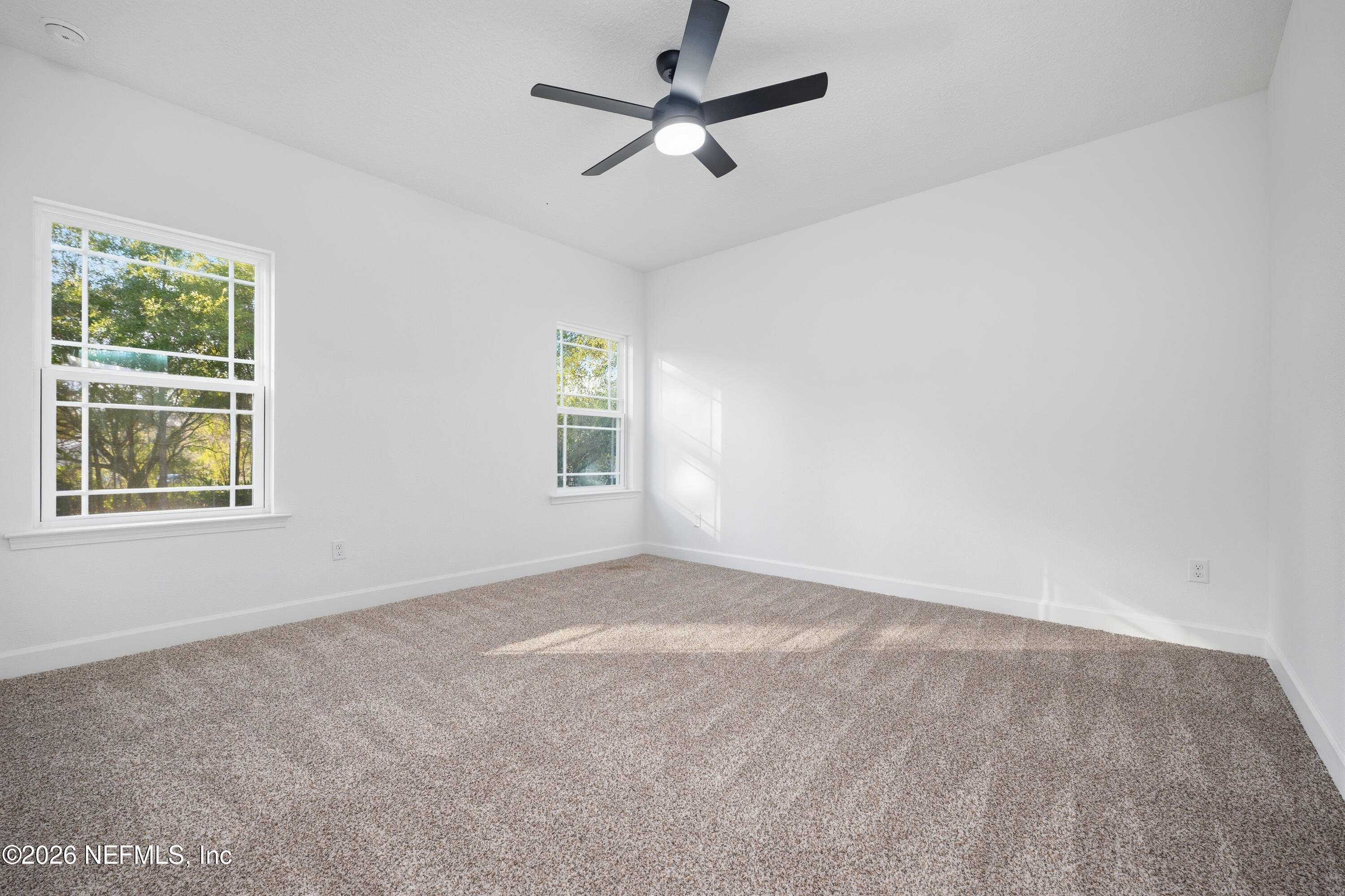 7596 Silver Sands Road Keystone Heights, FL 32656 - Photo 11 of 26 an empty room with windows and fan