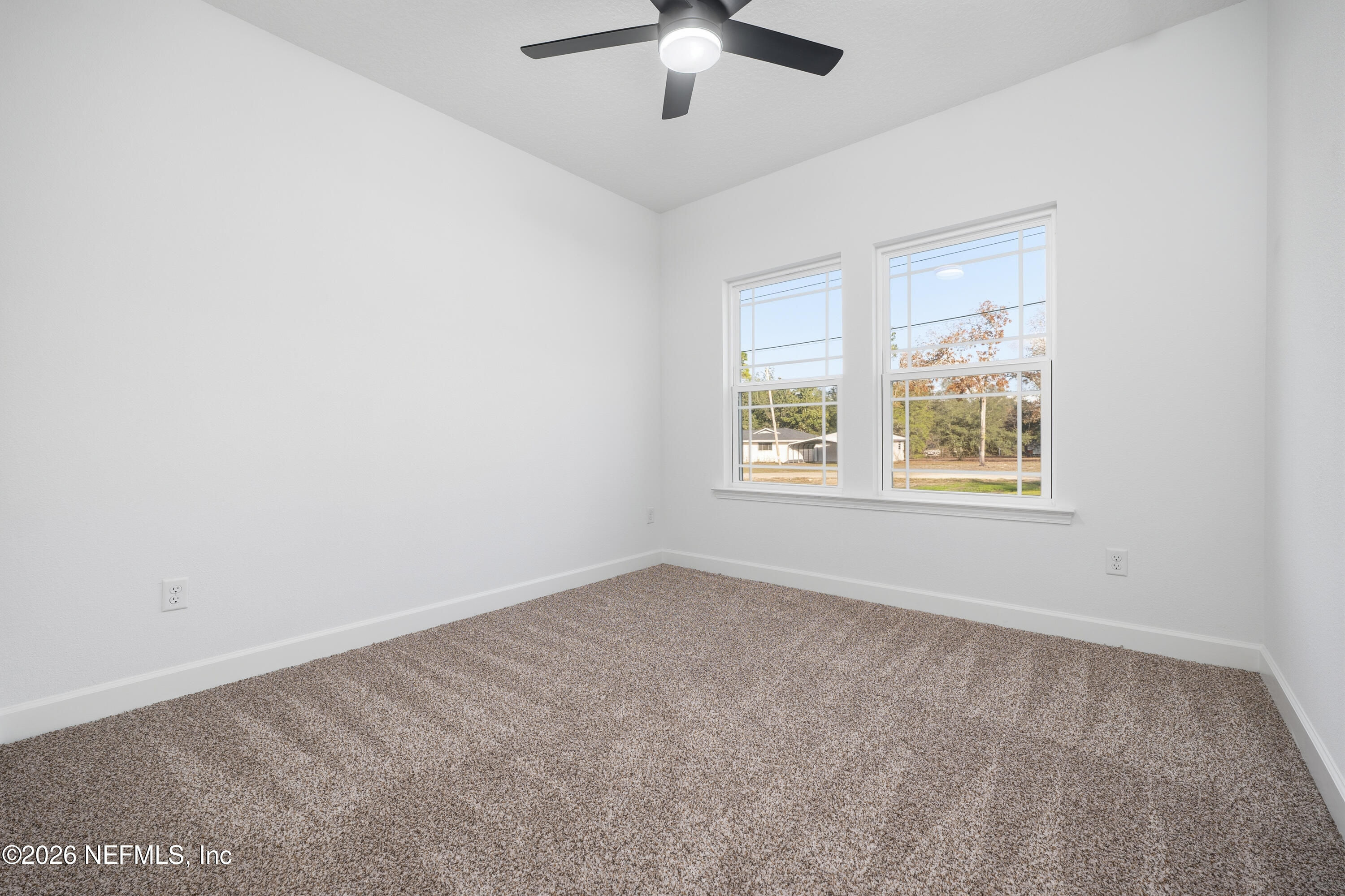 7596 Silver Sands Road Keystone Heights, FL 32656 - Photo 15 of 26 an empty room with a window and a fan