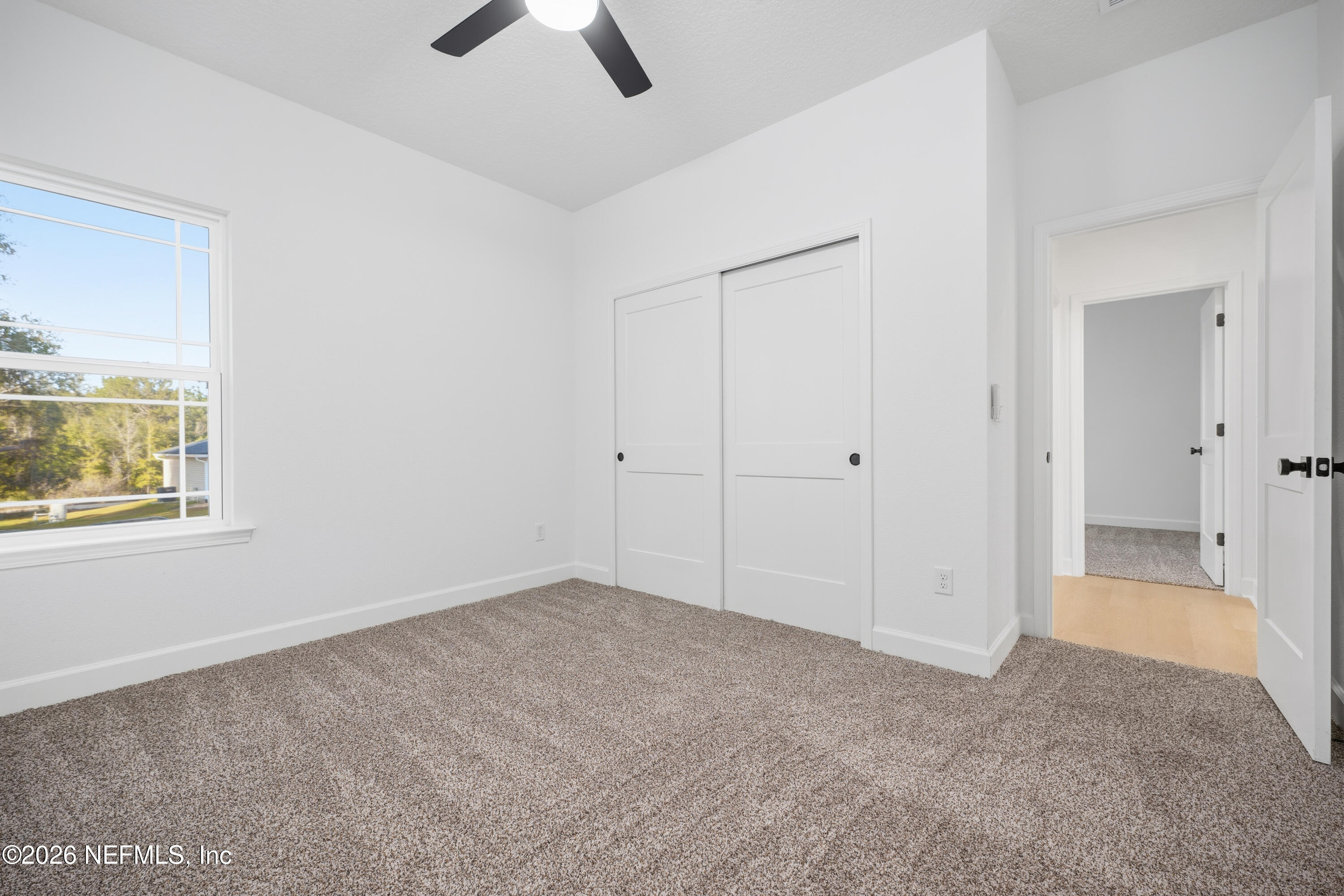 7596 Silver Sands Road Keystone Heights, FL 32656 - Photo 18 of 26 an empty room with chandelier fan