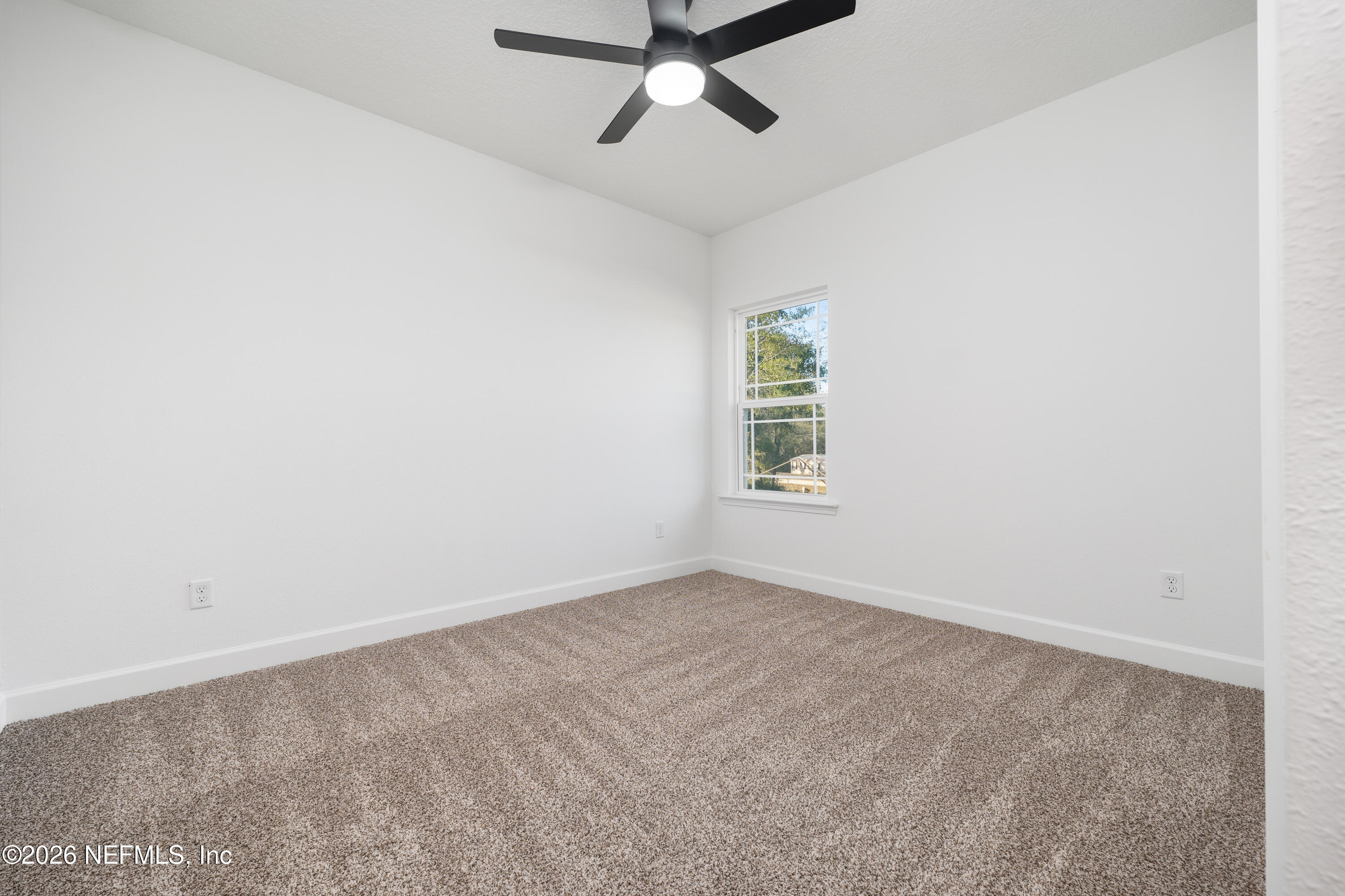 7596 Silver Sands Road Keystone Heights, FL 32656 - Photo 19 of 26 an empty room with a window and a ceiling fan