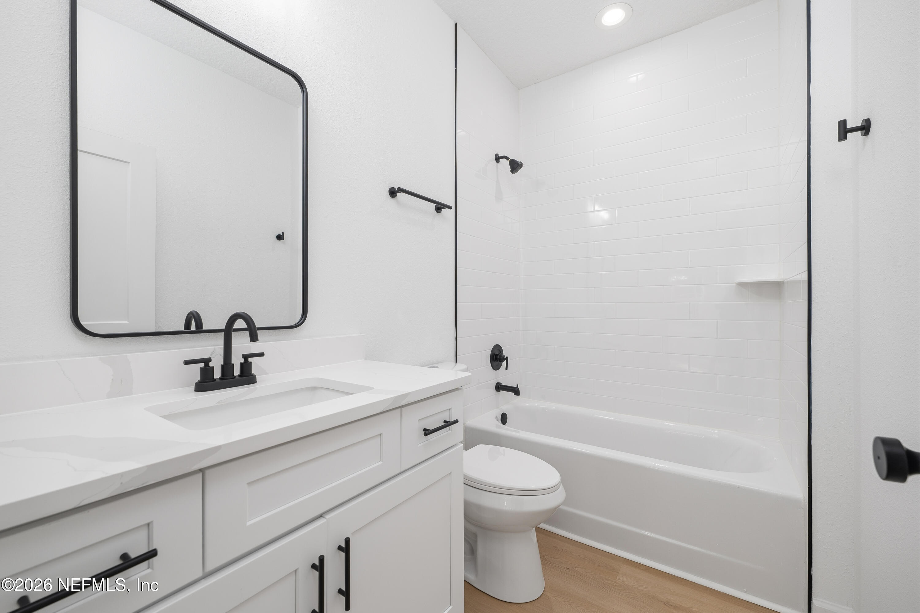 7596 Silver Sands Road Keystone Heights, FL 32656 - Photo 21 of 26 a bathroom with a sink a toilet and a mirror
