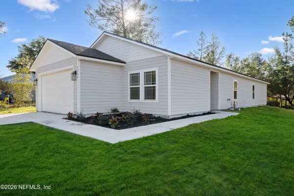 a view of an house with backyard space and garden