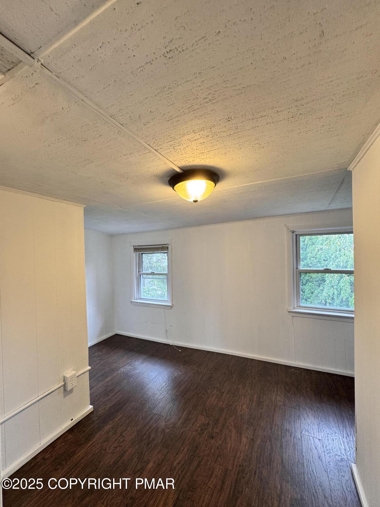 104 Serling Street Dupont, PA 18641 - Photo 13 of 18 an empty room with wooden floor and windows