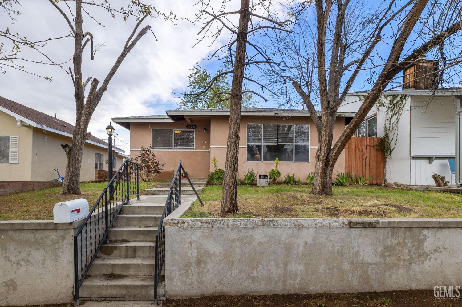 Undisclosed Address Taft, CA 93268 - Photo 1 of 14 a view of a house with backyard and trees
