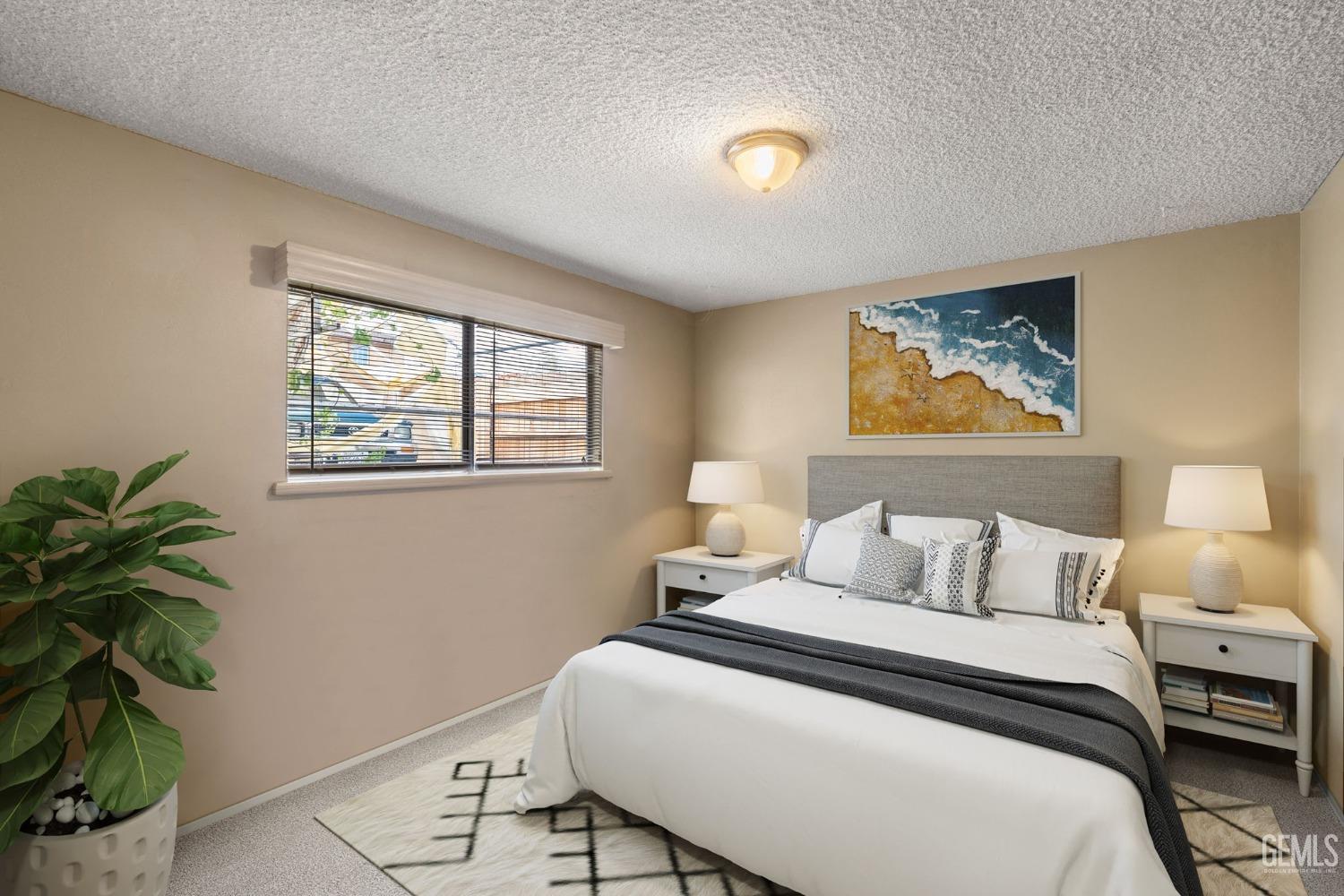 Undisclosed Address Taft, CA 93268 - Photo 9 of 14 a bedroom with a bed and a potted plant