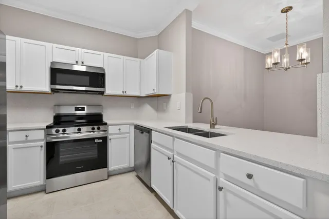 a hallway with sink and mirror