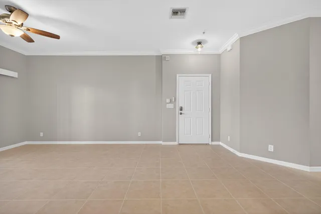 a view of a room with a kitchen and chandelier fan