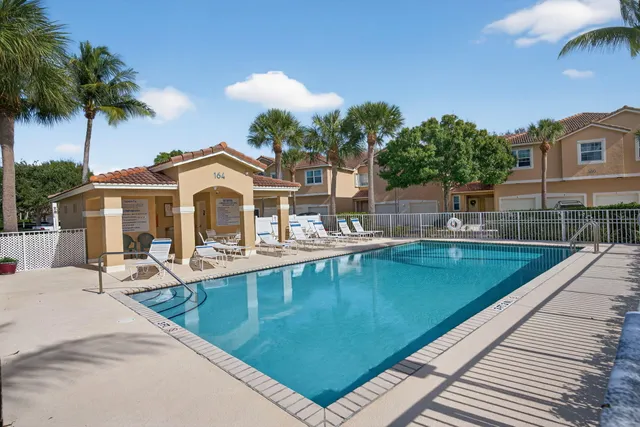 an aerial view of a house with a yard and garden